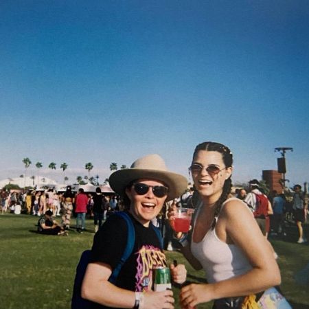 Brianna Hildebrand and Jonneke Grisham are having a good time at coachella, smiling with their shades on.